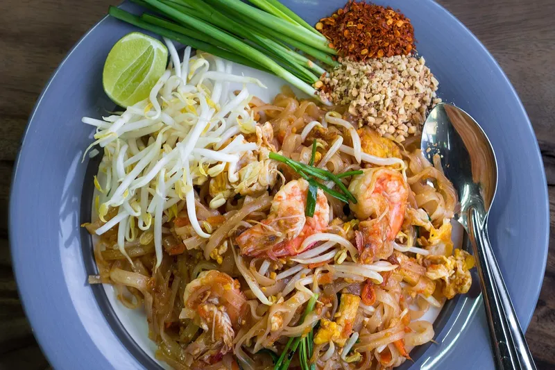 Пад-тай с креветками, ростками фасоли, лаймом, зеленью и арахисом